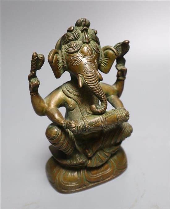 A group of indian bronze vessels, a figure of Ganesh, a Kashmiri polychrome wood vase, 24cm high